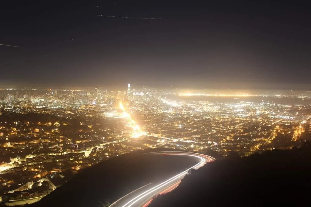 Twin Peaks at Night - light trail of cars travelling down a mountain photo